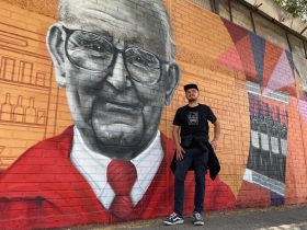 Foto de Fabrizio e Falcato junto a mural de comercial castro